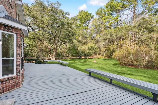 wooden terrace featuring a yard