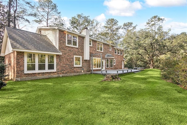 rear view of house featuring a yard