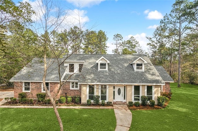 cape cod-style house with a front lawn