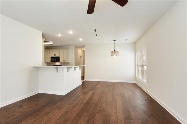 unfurnished living room featuring dark wood-style flooring, recessed lighting, a ceiling fan, and baseboards