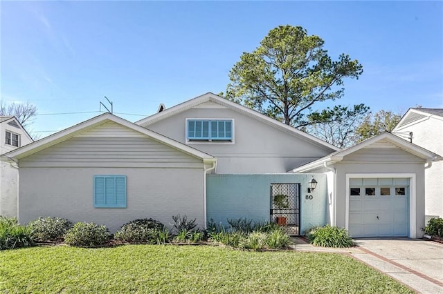 view of front of property with a garage and a front yard