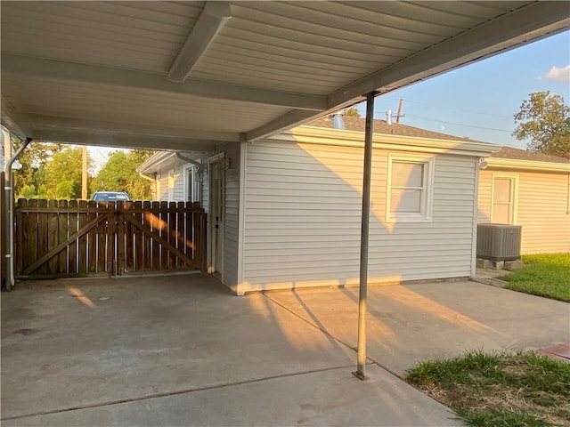 view of side of home with cooling unit and a carport