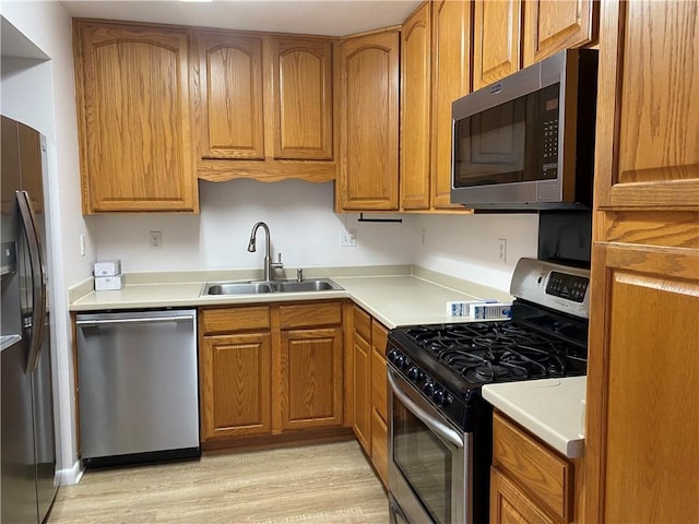 kitchen featuring sink, light hardwood / wood-style flooring, and stainless steel appliances