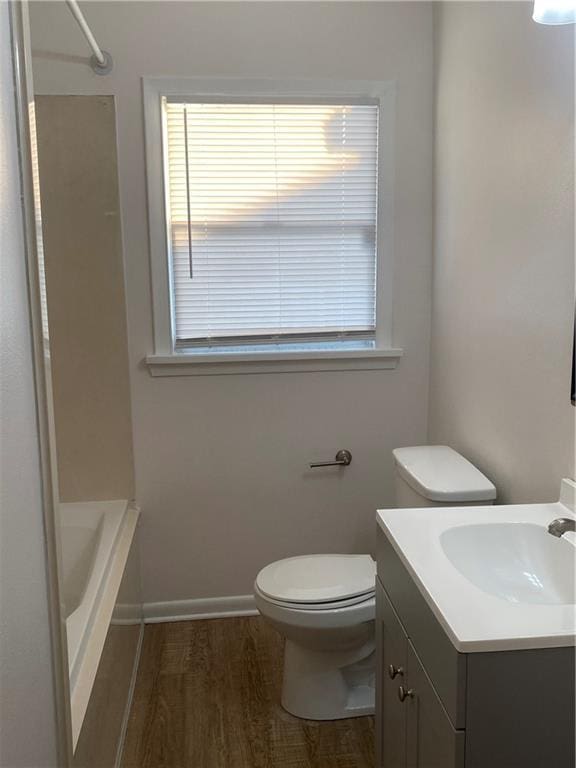 full bathroom with vanity, toilet, shower / bath combination, and wood-type flooring