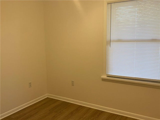 unfurnished room featuring dark hardwood / wood-style floors