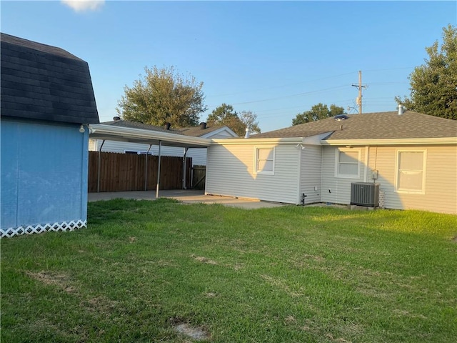 back of property featuring a yard, central AC unit, and a patio area