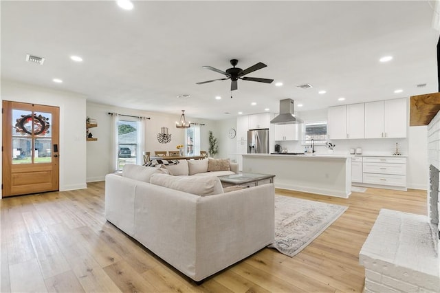 living room featuring ceiling fan and light wood-type flooring