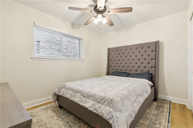 bedroom with light wood-type flooring and ceiling fan