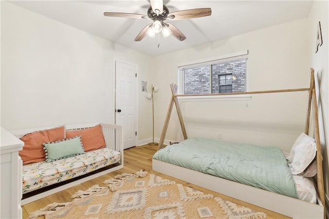 bedroom with ceiling fan and light hardwood / wood-style flooring