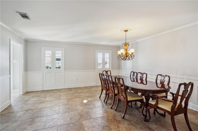 dining room featuring a notable chandelier, ornamental molding, and a wealth of natural light