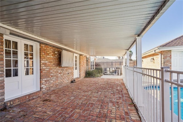 view of patio / terrace featuring a pool and french doors