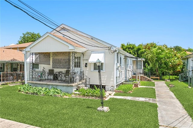 bungalow-style home with covered porch and a front lawn