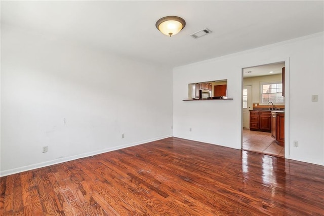 spare room with sink and light hardwood / wood-style floors