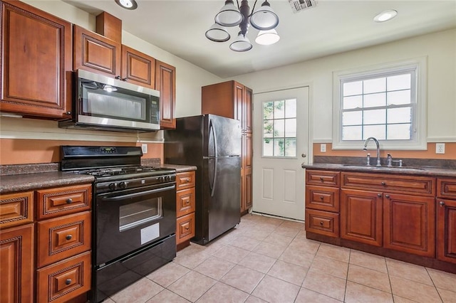 kitchen featuring sink, light tile patterned floors, a chandelier, and black appliances