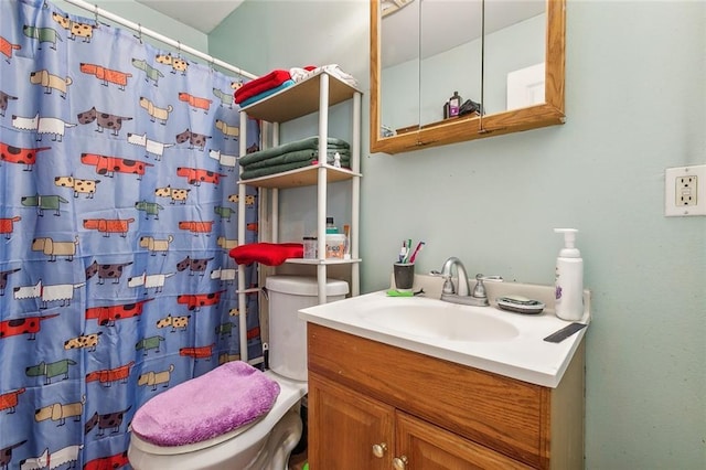 bathroom featuring vanity, toilet, and a shower with shower curtain