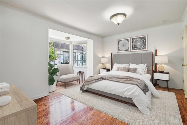 bedroom featuring hardwood / wood-style flooring and ornamental molding