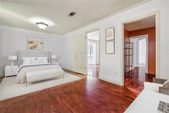 bedroom featuring dark wood-type flooring and ornamental molding