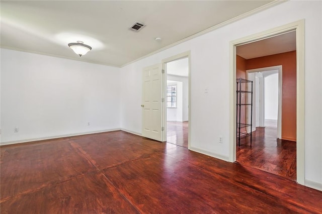 spare room with crown molding and wood-type flooring