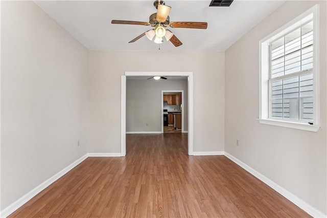 unfurnished room featuring ceiling fan and light wood-type flooring