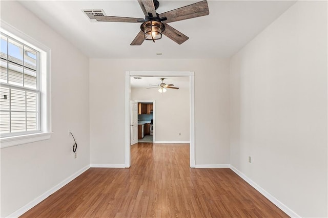 empty room featuring ceiling fan and light hardwood / wood-style floors