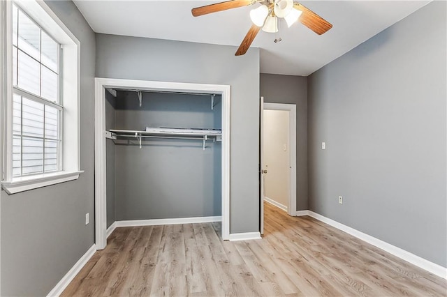 unfurnished bedroom featuring a closet, ceiling fan, and light wood-type flooring