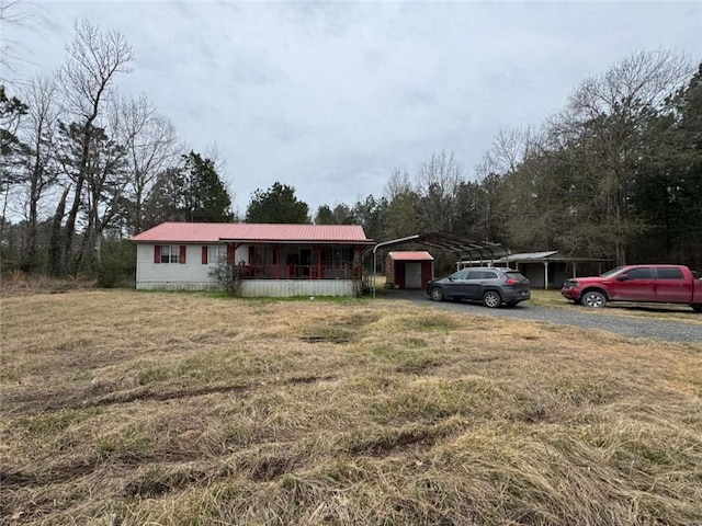 ranch-style home with a carport and a front lawn