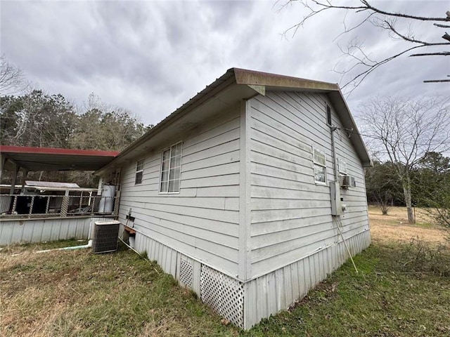 view of property exterior featuring cooling unit and a lawn