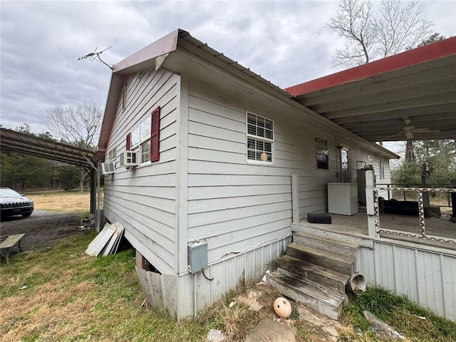 view of side of property featuring a deck and ceiling fan