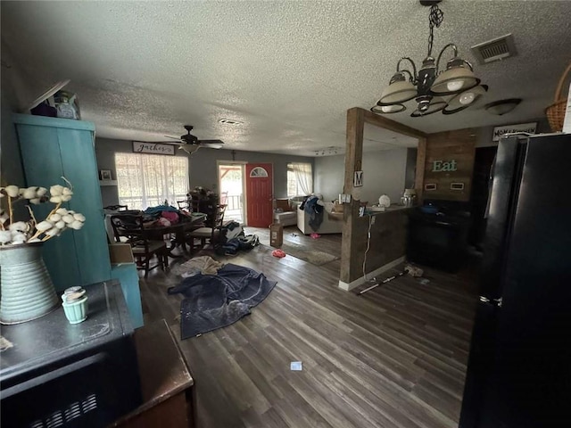 dining space with hardwood / wood-style flooring, ceiling fan, and a textured ceiling