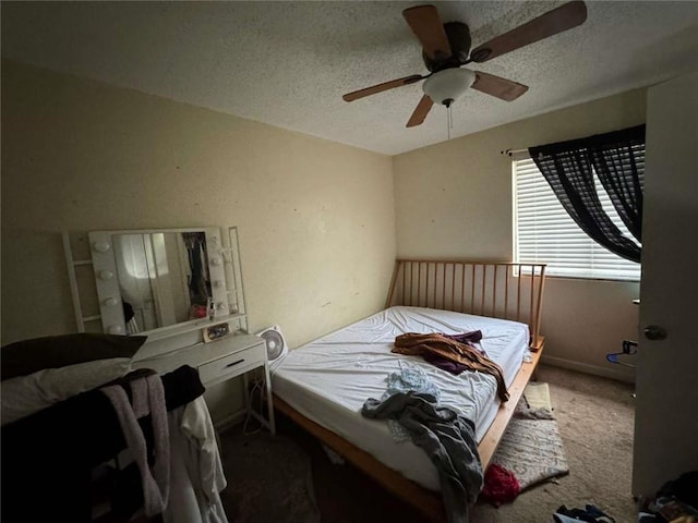 carpeted bedroom with ceiling fan and a textured ceiling