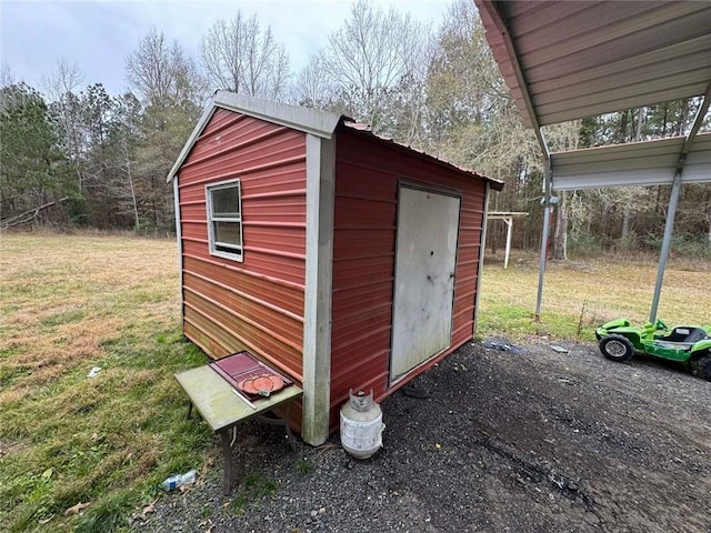 view of outbuilding with a yard