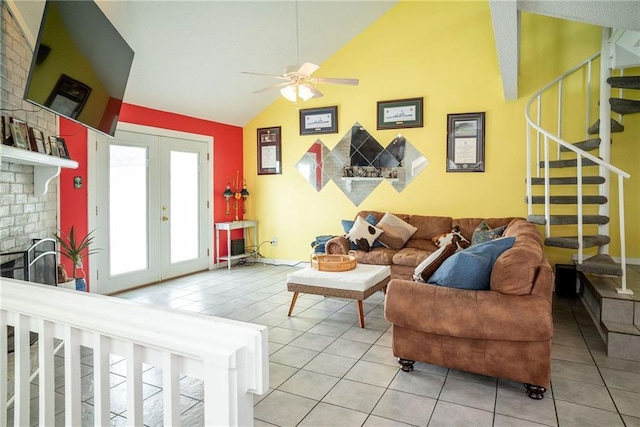 living room featuring light tile patterned floors, a fireplace, french doors, and ceiling fan