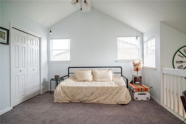 bedroom featuring multiple windows, vaulted ceiling, and carpet flooring