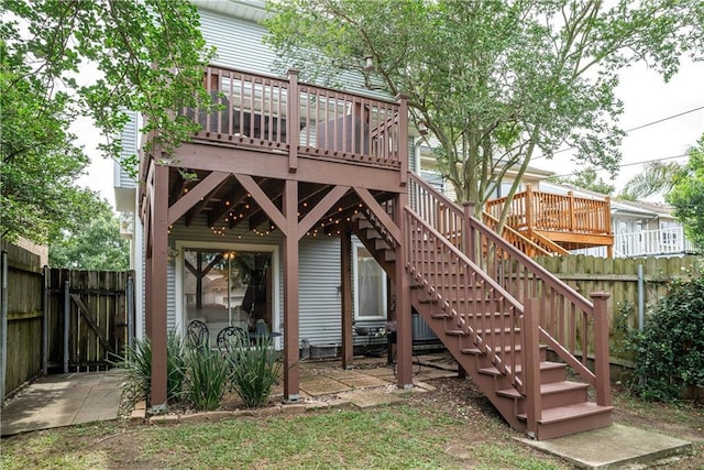 rear view of property featuring a wooden deck