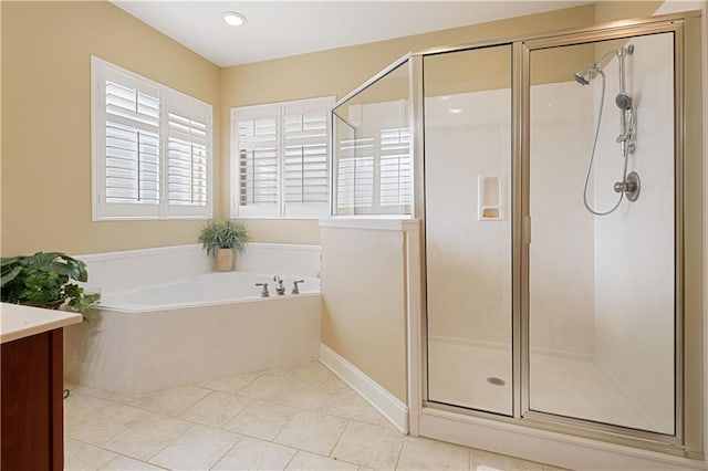 bathroom with tile patterned flooring, plus walk in shower, and vanity