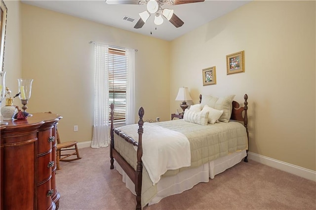 bedroom with ceiling fan and light carpet