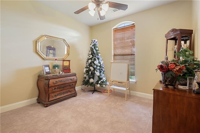 sitting room featuring ceiling fan and light colored carpet