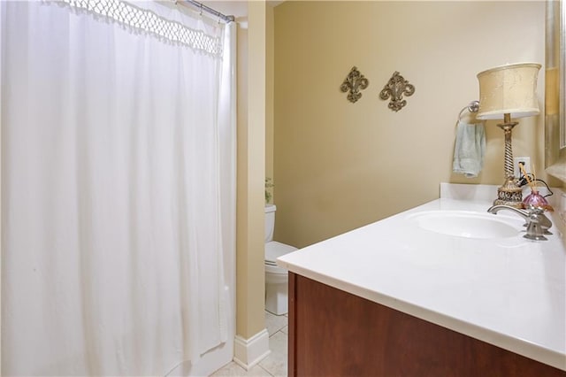 bathroom with vanity, toilet, and tile patterned flooring