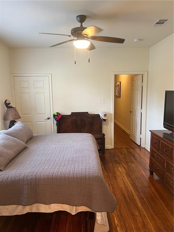 bedroom with ceiling fan and dark hardwood / wood-style floors