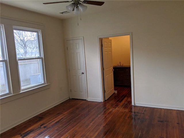 unfurnished bedroom with dark hardwood / wood-style flooring and ceiling fan