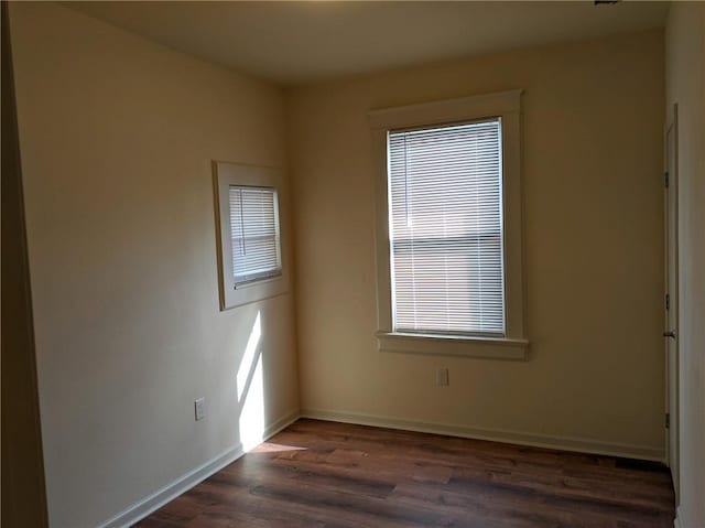 spare room featuring dark hardwood / wood-style floors