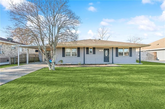 ranch-style home featuring a carport and a front yard