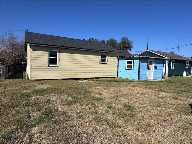 rear view of property with a lawn