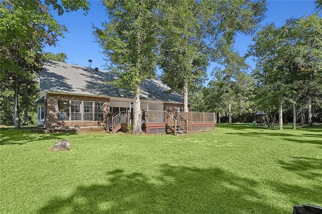 view of yard featuring a playground and a wooden deck