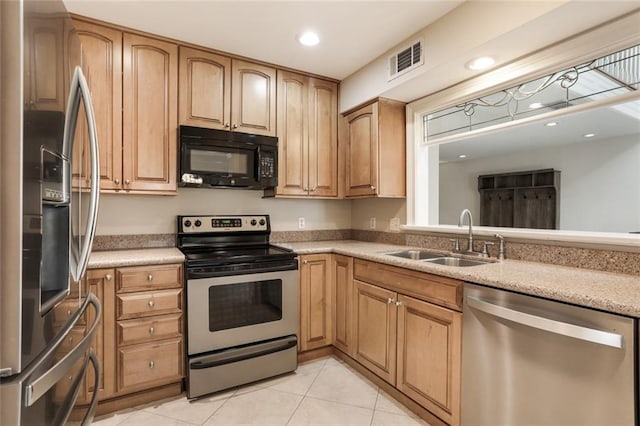 kitchen with light tile patterned flooring, appliances with stainless steel finishes, and sink