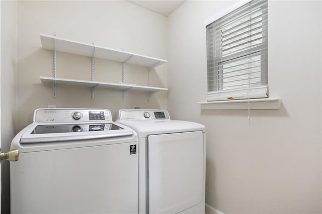 clothes washing area featuring washer and clothes dryer