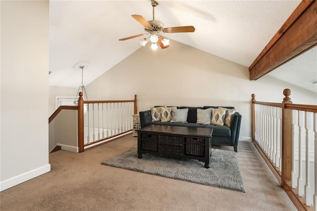 carpeted living room with ceiling fan and lofted ceiling with beams