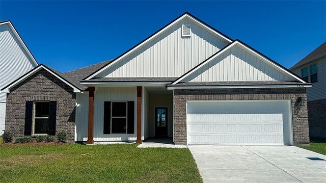 5428 Wake Reserve Rd, Slidell, LA 70461 - view of front facade featuring brick siding, an attached garage, concrete driveway, and a front lawn