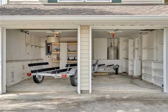 garage featuring a garage door opener, electric panel, and electric water heater