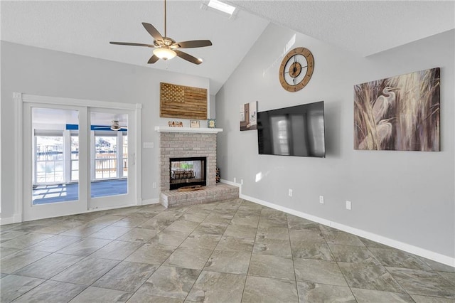 unfurnished living room with a brick fireplace, a textured ceiling, vaulted ceiling, and ceiling fan